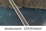 Small photo of Aerial View of a Solitary Bridge Over a River. This captivating aerial photograph showcases the stunning simplicity of a solitary bridge crossing over a serene river.