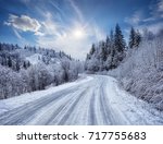 Road in the mountains covered with snow. Winter landscape. The concept of freedom and movement.