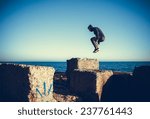 man performs freerunning jump on stones