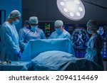 Small photo of Multiracial team of professional medical surgeons performs the surgical operation in a modern hospital. Doctors are working to save the patient. Medicine, health and neurosurgery.