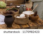 Small photo of Medieval food selection including eggs, cream and fruit in traditional wooden bowls or trenchers