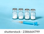 Small photo of Syringe and needle with glass medical ampoule vials for injection. Medicine is dry white drug penicillin powder or liquid with of aqueous solution in ampulla