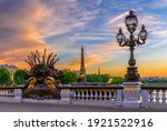 Small photo of Street lantern on the Alexandre III Bridge with the Eiffel Tower in the background in Paris, France. Architecture and landmarks of Paris. Postcard of Paris