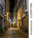 Small photo of Night view of narrow street in Florence, Tuscany, Italy. Architecture and landmark of Florence. Cityscape of Florence