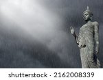Black buddha on clouds and rain ...