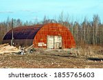 Small photo of View of an old, rusty, abandoned hangar. An image of decrepitude or a natural disaster.