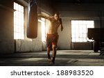 Young Man Boxing Workout In An...