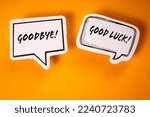 Small photo of Goodbye and Good Luck. Text on speech bubbles. Yellow background.