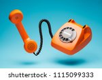 Old orange telephone rings with ...