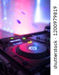 Small photo of DJ deejay mixing desk equipment in wedding receoption party disco with color discotheque lights.