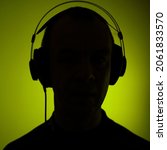 Small photo of Dj deejay electronic wearing music headphones with coloured lights plain studio background.