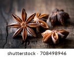 Anise stars closeup against dark rustic wooden background