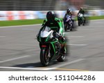 Motorcycle racers compete at high speed on the race track