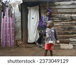 Small photo of SLUM OF NAIROBI, KENYA - NOVEMBER 18, 2022: Children at their home in the slums of Nairobi. Largest urban slum in Africa. Kenya