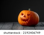 Jack-o-lantern on black background. Creepy pumpkin for Halloween. Halloween scary background.