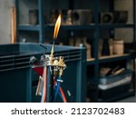 Glassblowing Work Place and Torch Pilot Flame, close up horizontal photo