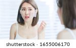 Small photo of Young asian skin care woman upset after use oil blotting paper on her face