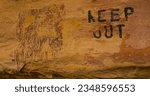 Small photo of “KEEP OUT.” Ancient pictograph, otherworldly, mysterious and unknown, defaced by a Utah rancher, warning away visitors in the 1950s.