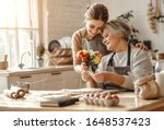 Small photo of happy mother's day! family old grandmother mother-in-law and daughter-in-law daughter congratulate on the holiday, give flowers