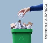 Small photo of Woman putting paper in the waste bin, separate waste collection and recycling concept