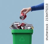 Small photo of Woman throwing a metal can in the recycling bin, separate waste collection concept