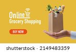 Small photo of Online grocery shopping and home delivery: hand holding a tiny grocery bag full of goods