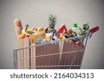 Shopping cart full of fresh groceries, grocery shopping concept