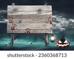 Small photo of Old wooden sign with bloody handprints and scary Halloween pumpkins, blank copy space