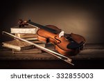 Violin  Bow And Old Books On A...