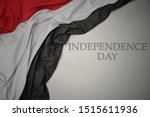 waving colorful national flag of yemen on a gray background with text independence day. concept