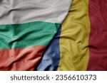 big waving national colorful flag of bulgaria and national flag of romania . macro