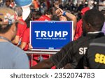 Small photo of Milwaukee, Wisconsin, USA - August 23, 2023: A supporter of former President Donald Trump holds a protest sign at the entrance to the first 2024 Republican Presidential Debate.