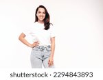 Young beautiful woman. Trendy carefree model in casual summer white T-shirt and blue jeans. Positive female isolated on white in studio. Cheerful and happy. Copy space, mockup