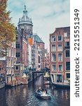Small photo of AMSTERDAM, NETHERLANDS - MAY 8, 2017: Canal cruise tourist boat in Amsterdam canal. Amsterdam, capital of the Netherlands, has more than one hundred kilometers of canals
