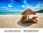 Vacation holidays background wallpaper - two beach lounge chairs under tent on beach. Sihanoukville, Cambodia