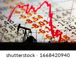 Small photo of Stock market declining chart and oil pump jack - abstract background