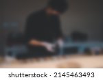Blur background of chef in uniform wearing black face mask cooking in a commercial kitchen.
