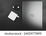 Small photo of Bangkok, Thailand - December 28, 2023 : Power adapter 96 watts with black braided USB-C cable for charger placed together Apple Macbook Pro with M3 Max new chip Space Black