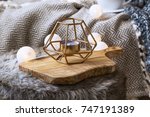Home deco indoor with candle holder and light bulbs, cozy blanket and faux fur,cozy winter interior details 