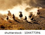 Cowboys Chasing Wilding Horses. ...