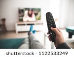 Man watching smart tv controlled by smart remote - point of view perspective