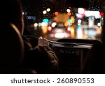 Driving in night scenery, hands on steering wheel.