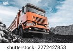 Small photo of Large quarry dump truck. Dump truck carrying coal, sand and rock. Trucks moving on dirt country road in forest. Mining truck mining machinery to transport coal from open-pit. Transportation of mineral