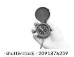 Small photo of round compass in hand isolated on white background for abstract image with place for text as symbol of tourism with compass, travel with compass and outdoor activities with compass
