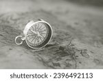 Small photo of black and white photo of round compass as symbol of tourism with compass, travel with compass and outdoor activities with compass