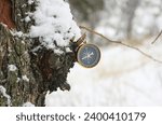 Small photo of round compass on natural wooden background as symbol of tourism with compass, travel with compass and outdoor activities with compass
