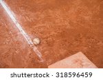 Small photo of baseball and base on baseball field