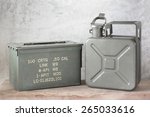 still life photography : old Army green jerrycan ( fuel canister ) and bullet box ( ammo crate ) on old wood with concrete background