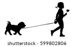 little girl walks dog holding a ...