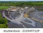 Small photo of Aerial top view with mobile crushers open pit sand into mobile jaw crusher heavy machinery in the mining quarry, excavators and dump truck